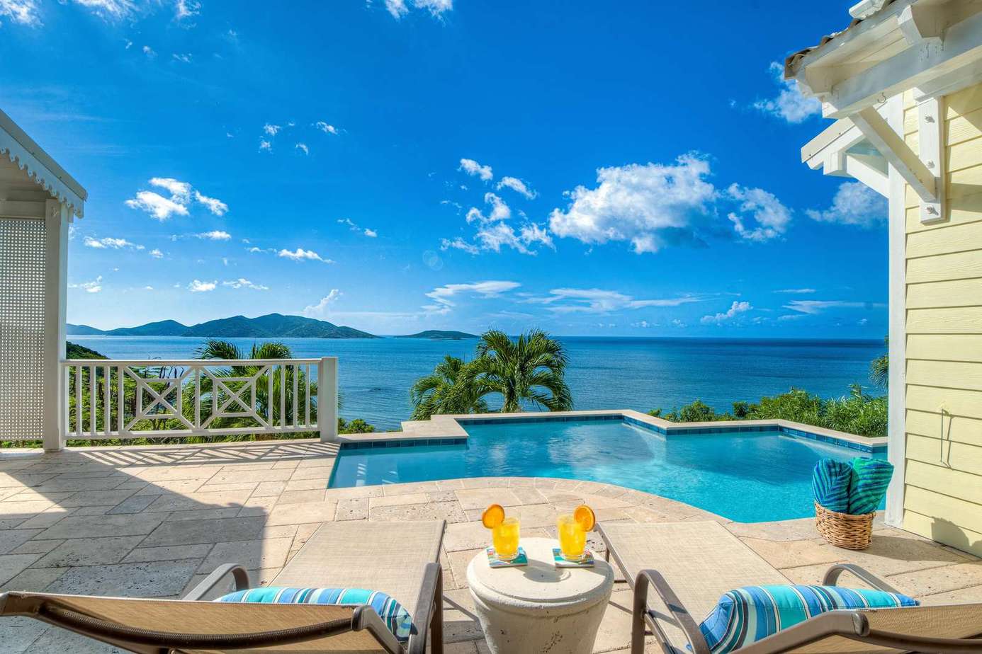 Sun-soaked patio with infinity pool and ocean views
