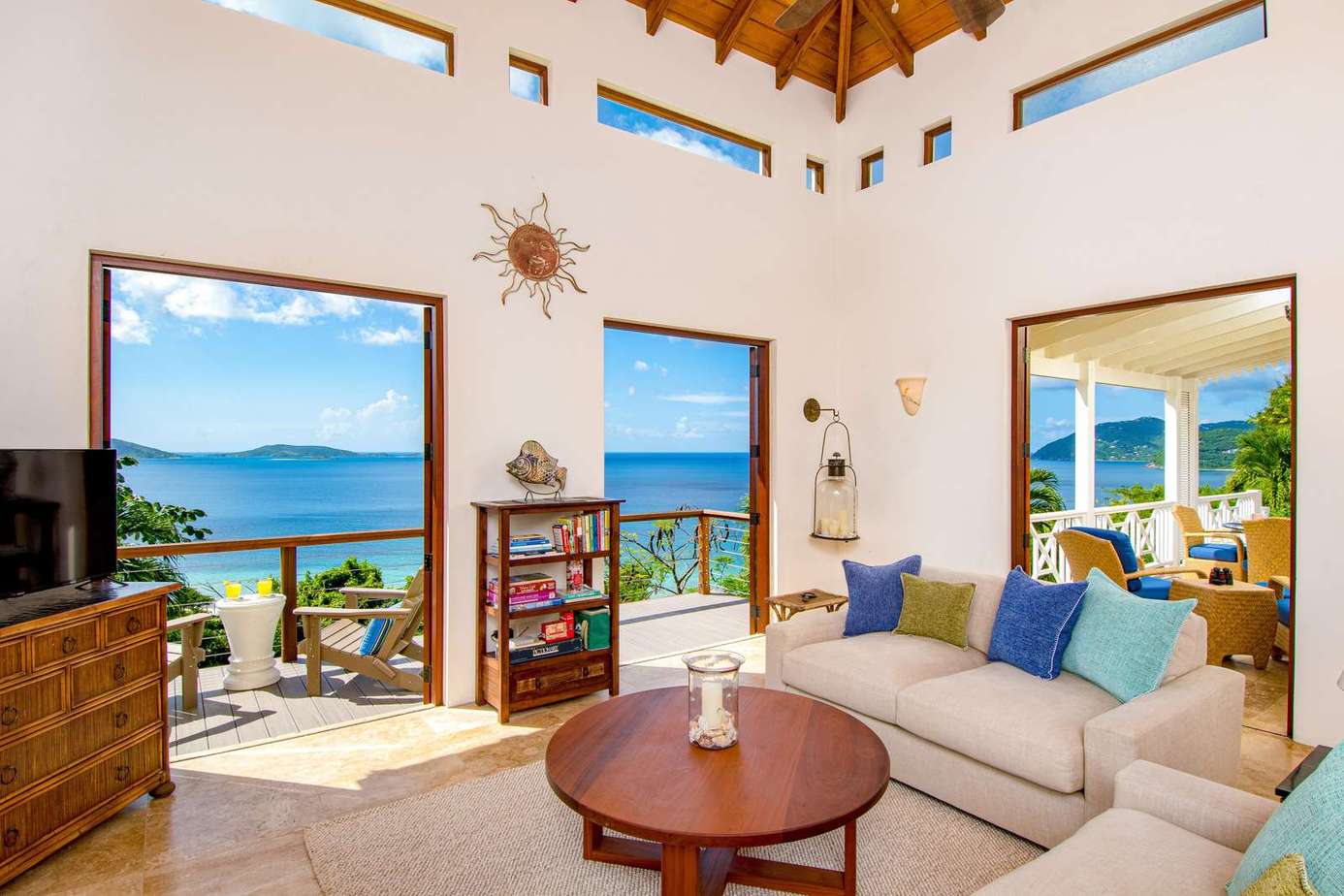 Sunlit living room with panoramic ocean views and cozy seating.