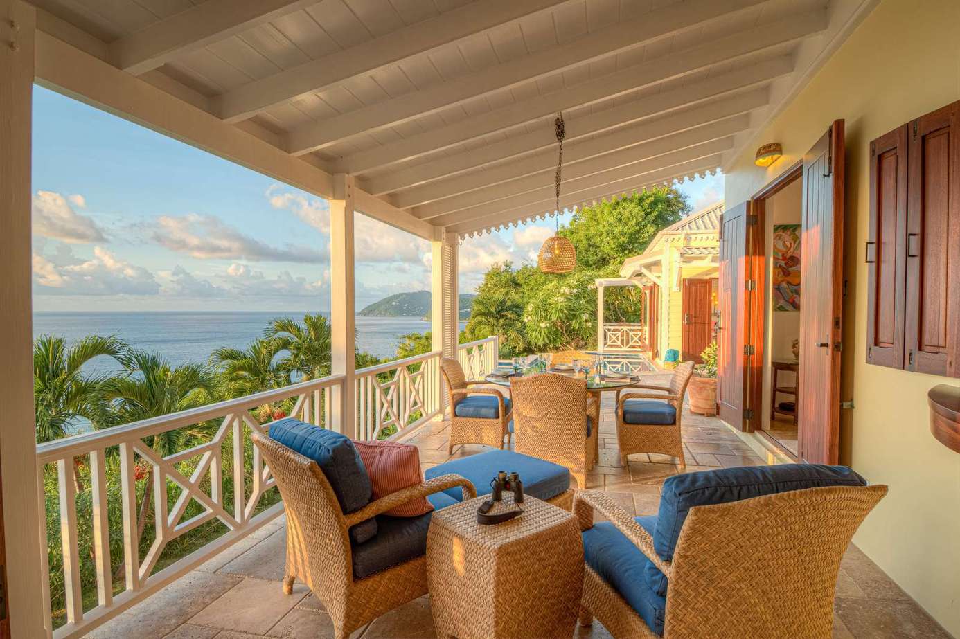 Spacious ocean-view patio with cozy seating for sunset relaxation