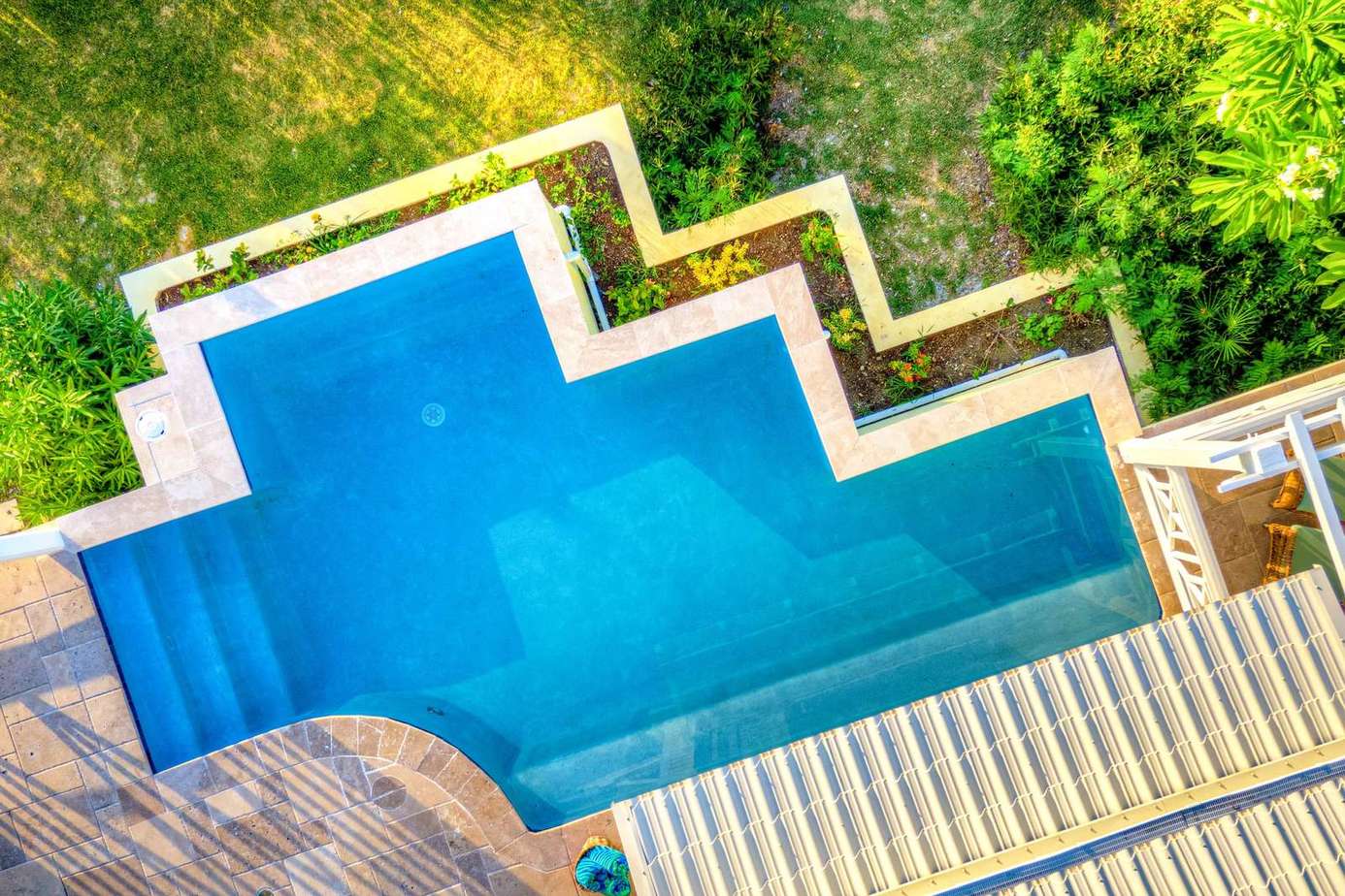 Sparkling geometric pool surrounded by lush greenery for ultimate relaxation