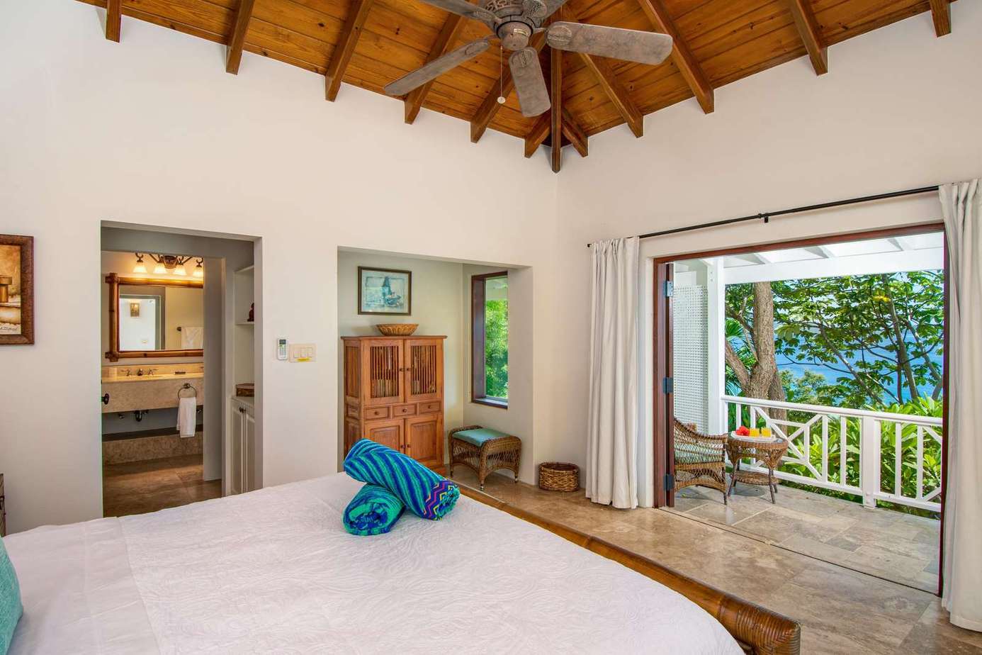 Spacious bedroom with vaulted ceilings and ocean views