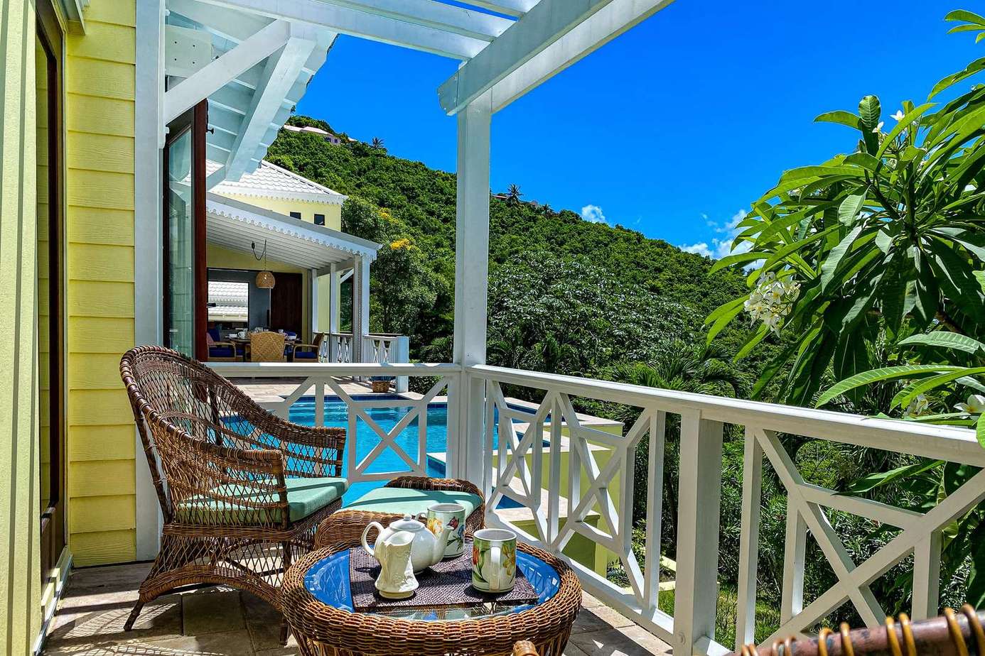 Cozy balcony retreat with lush mountain views and morning coffee spot