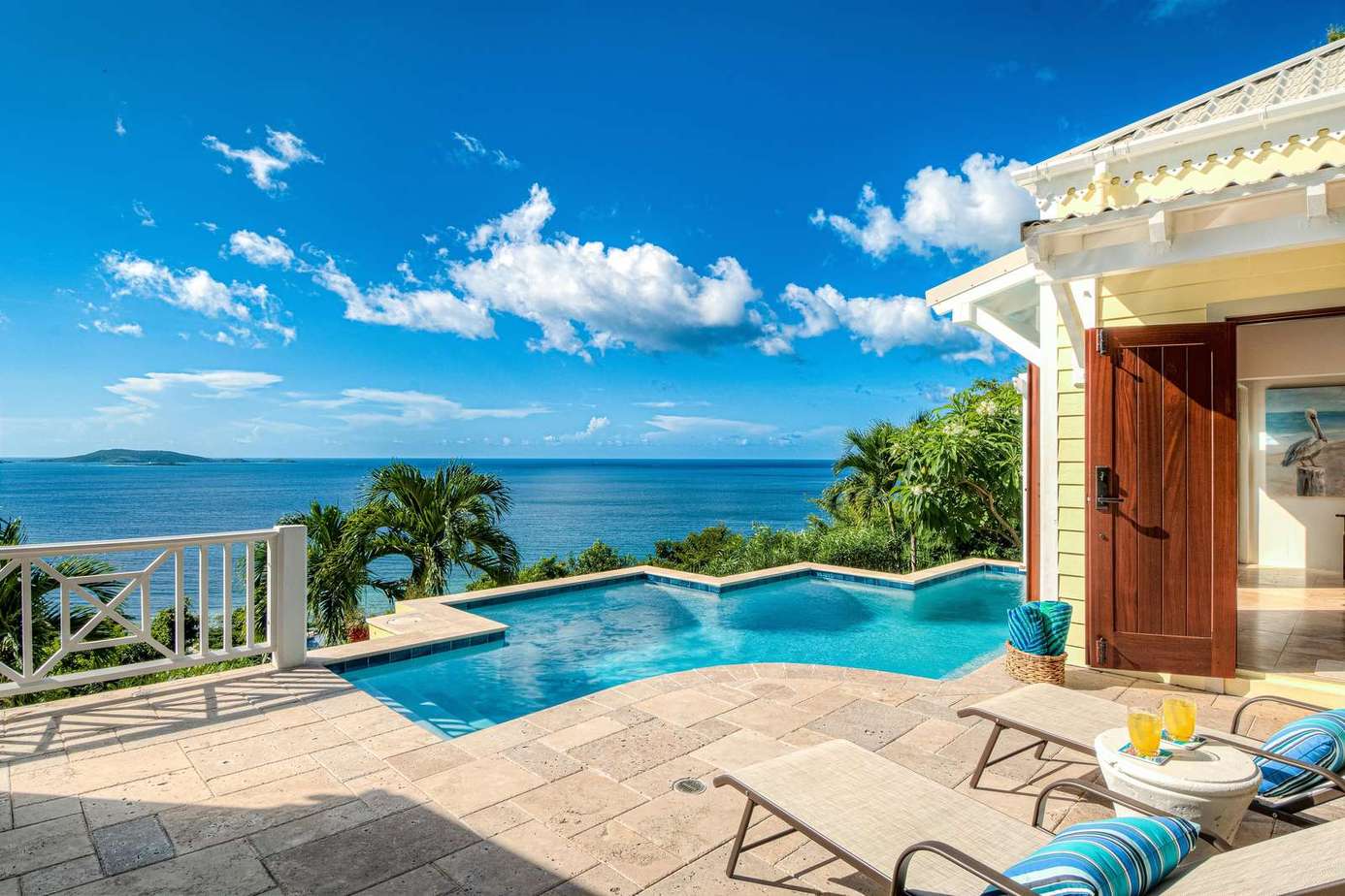 Ocean-view patio with infinity pool and lounge chairs