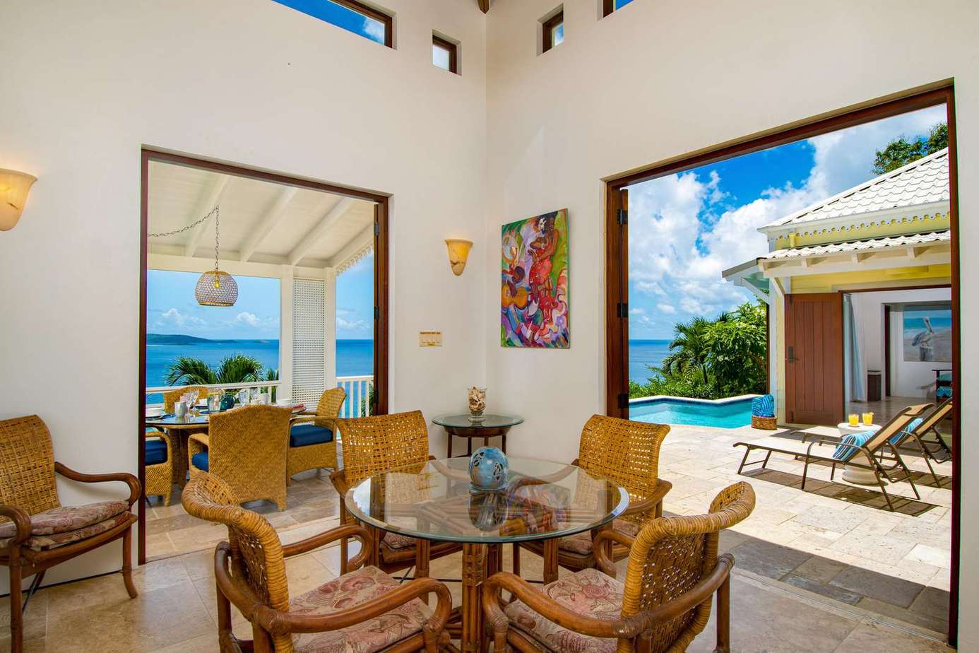 Sunlit dining area with ocean views and seamless indoor-outdoor flow