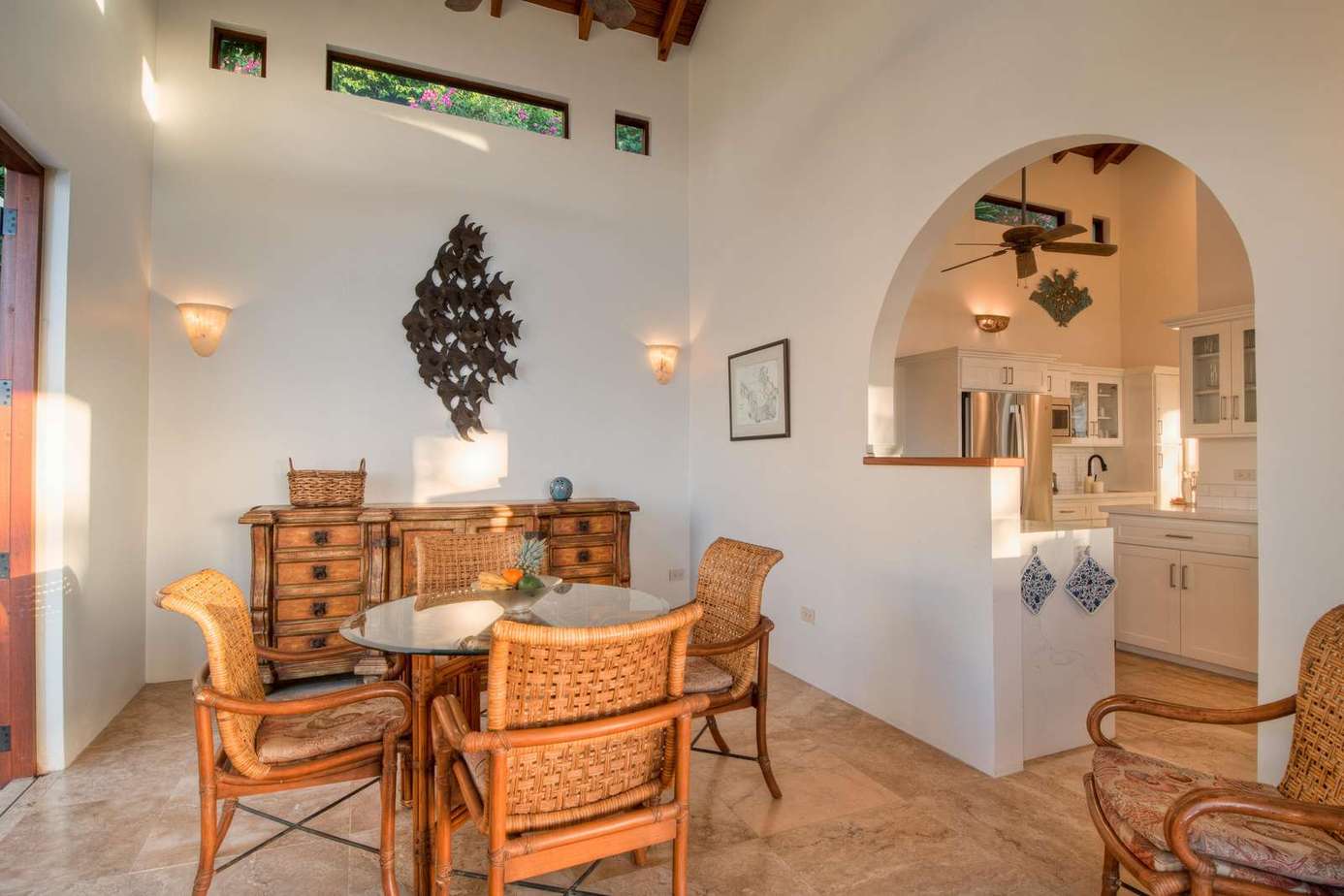 Sunlit dining area with elegant arches and warm tones