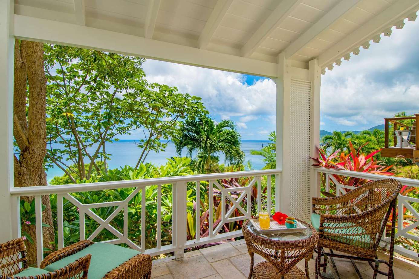 Tranquil covered patio with lush garden and ocean views