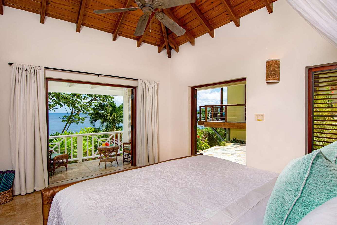 Serene bedroom with vaulted ceiling and ocean views