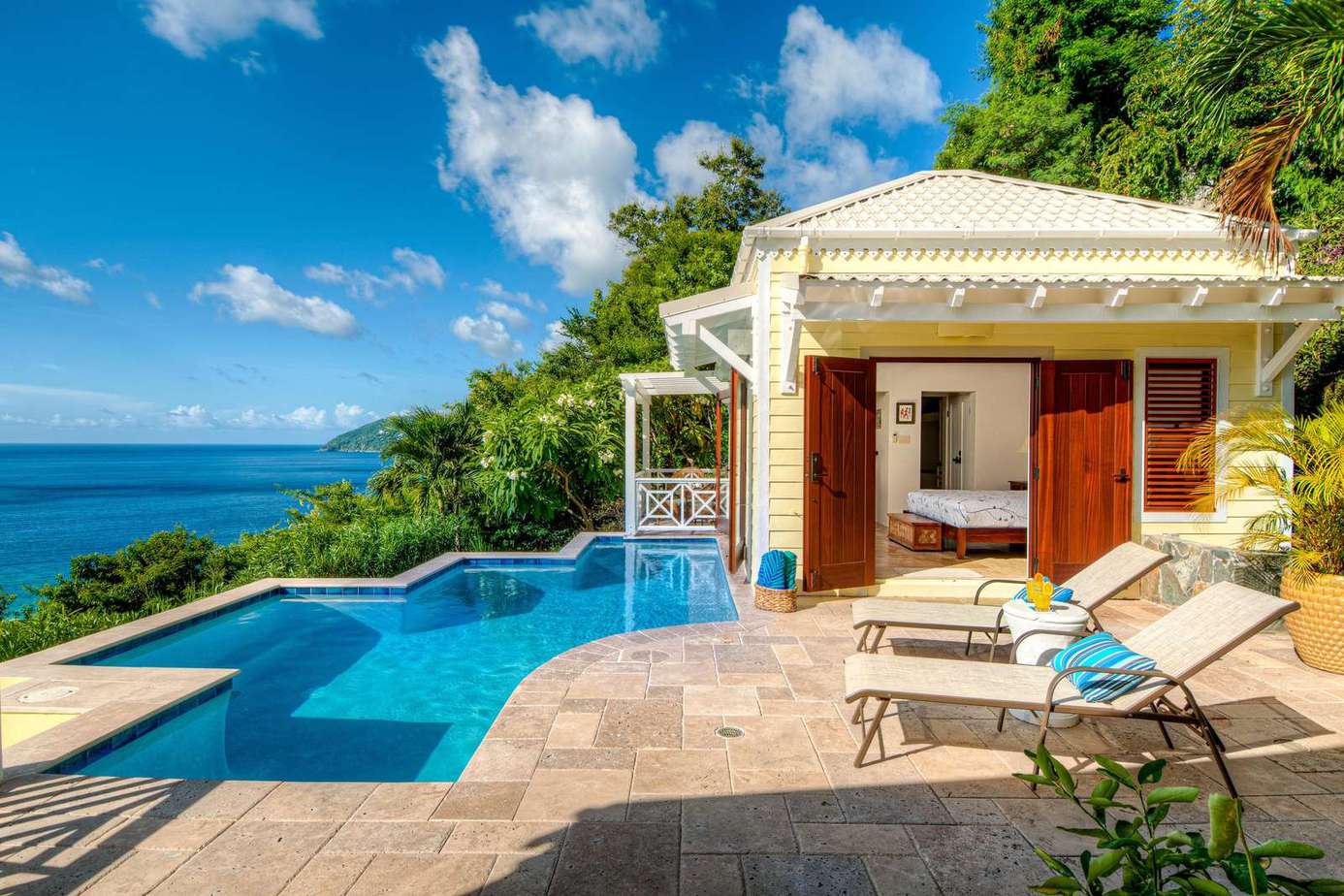 Secluded poolside patio with stunning ocean views and lounge chairs