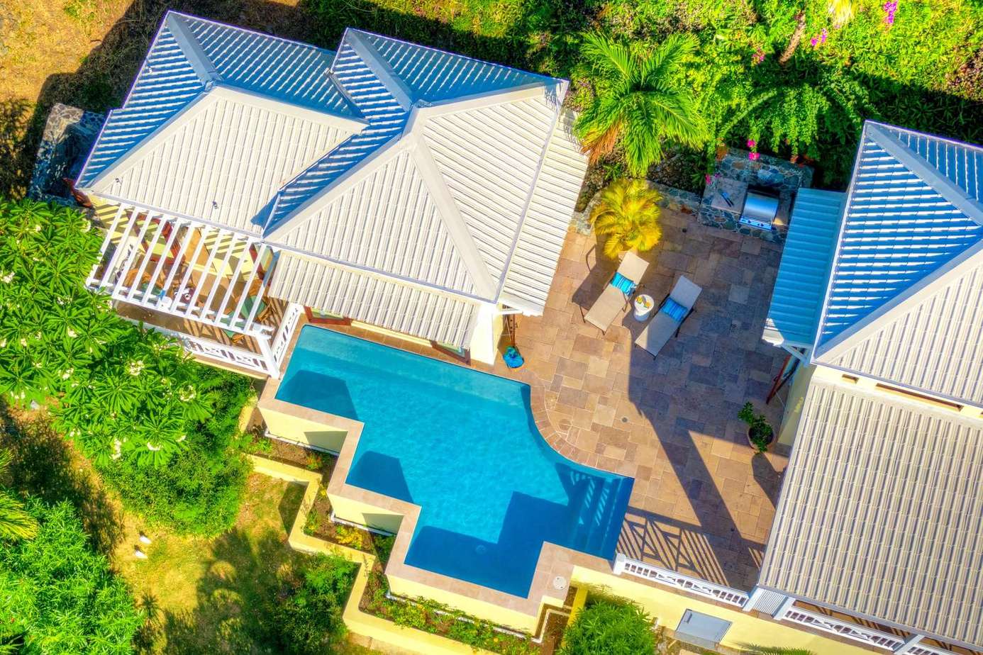 Private pool oasis with spacious sun deck and lush greenery