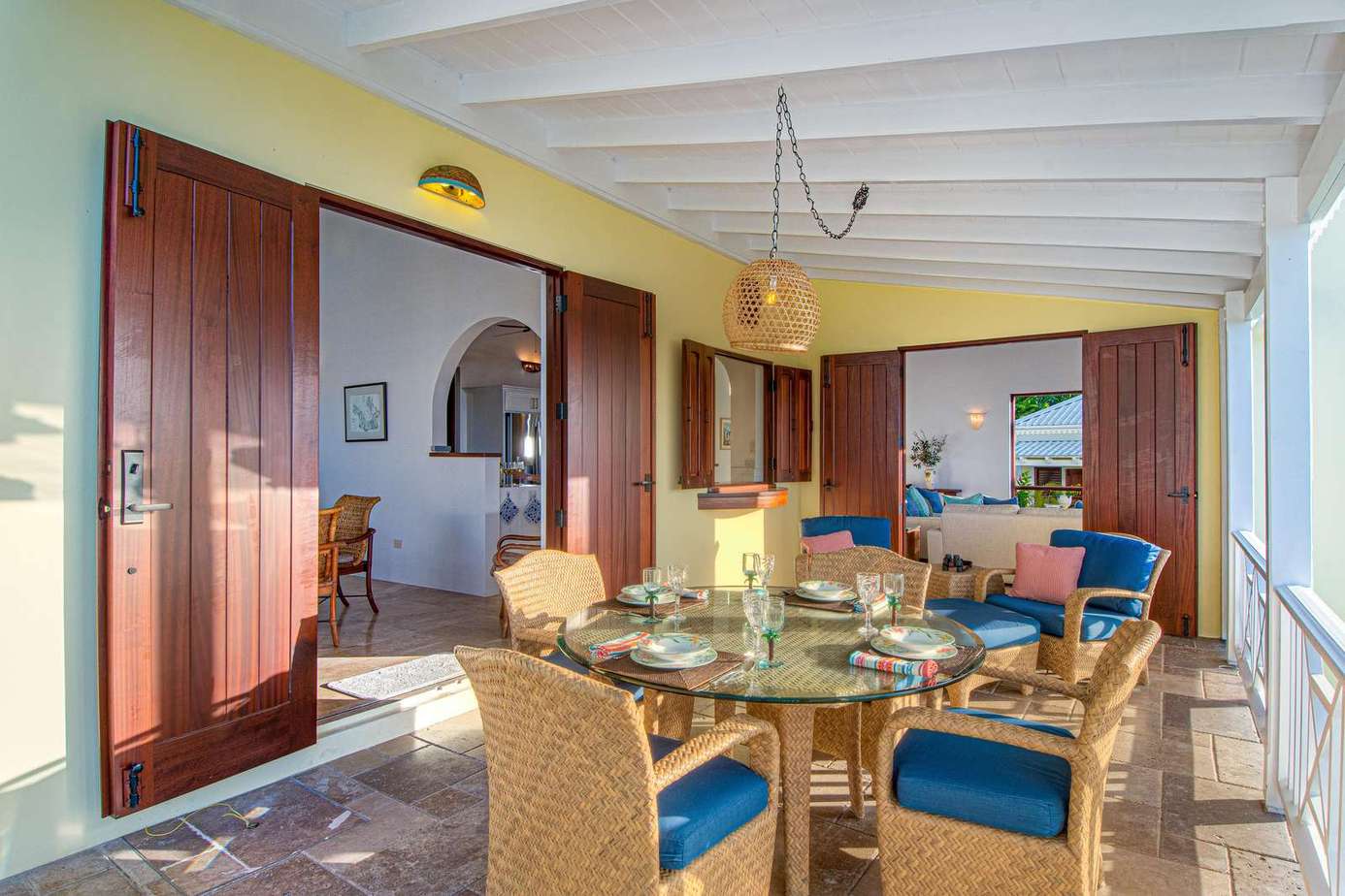 Sunlit screened porch with cozy seating and dining area