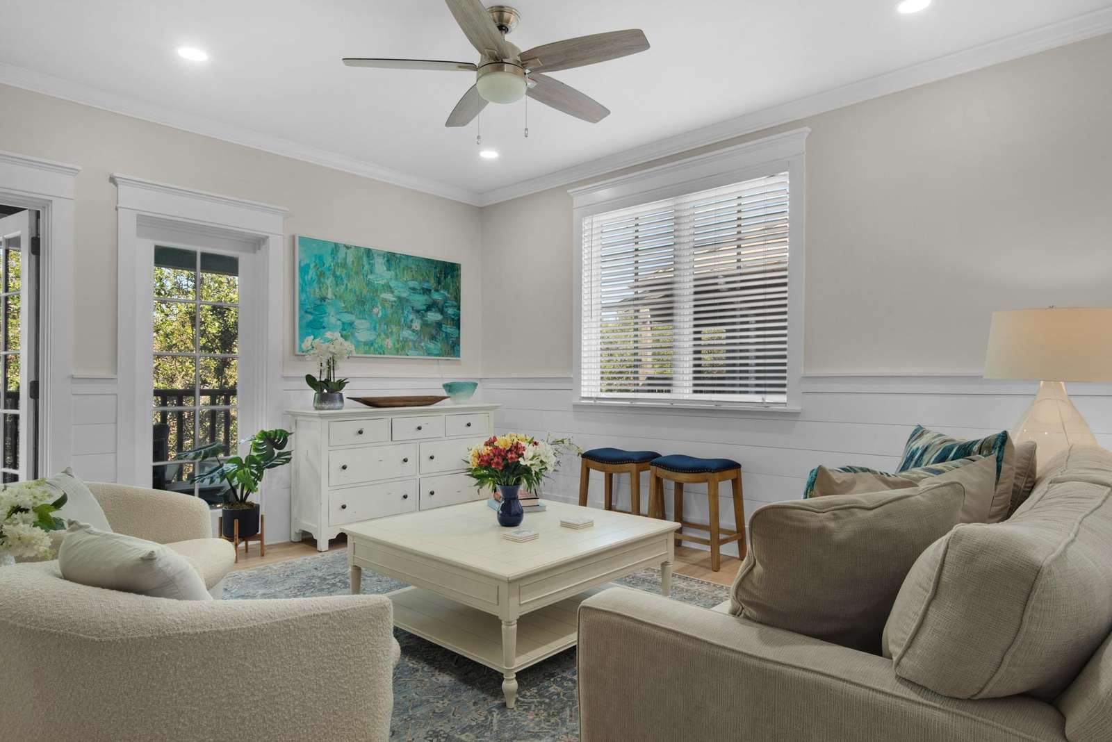 Cozy living room with bright windows and modern comfort - property