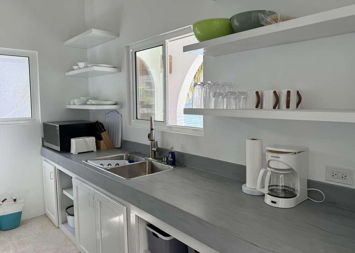 Bright, airy kitchen with modern amenities and open shelving