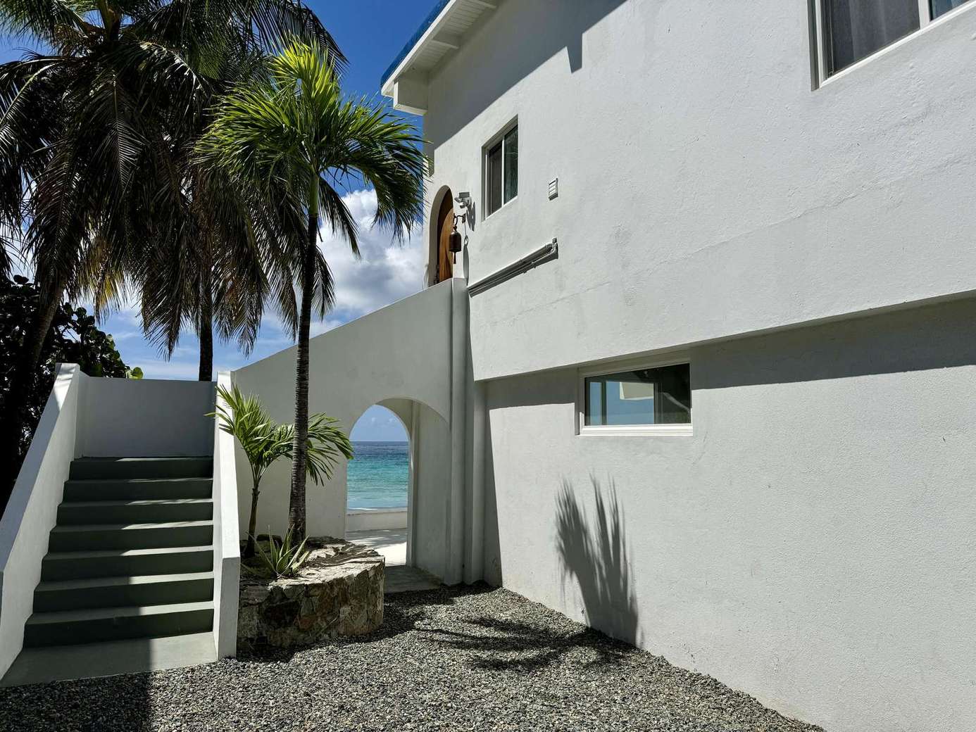 Secluded patio with ocean view and tropical breeze