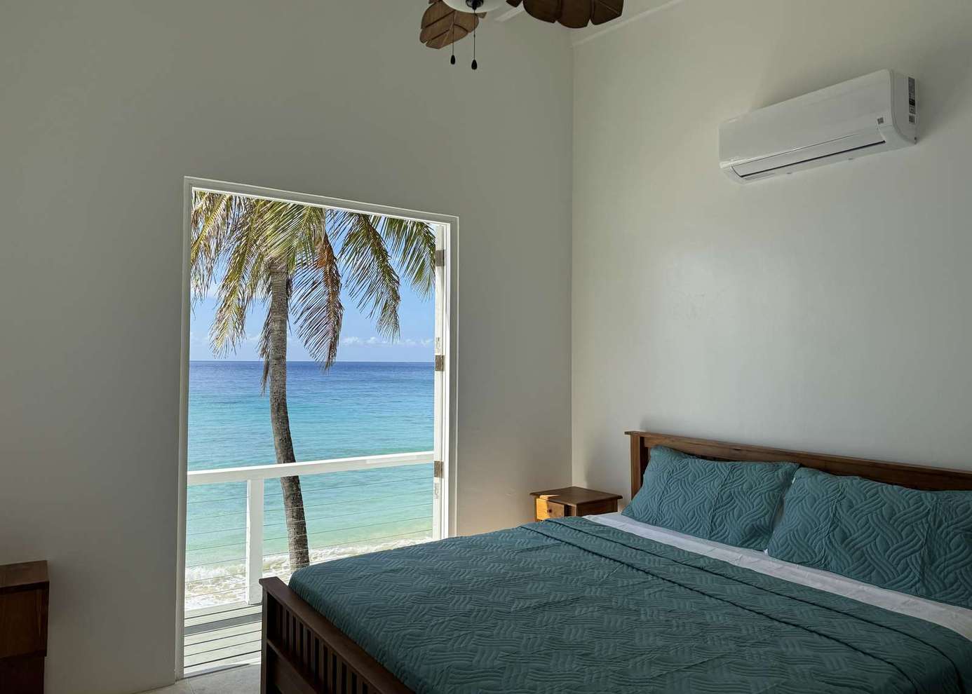 Oceanfront bedroom with stunning palm-framed views