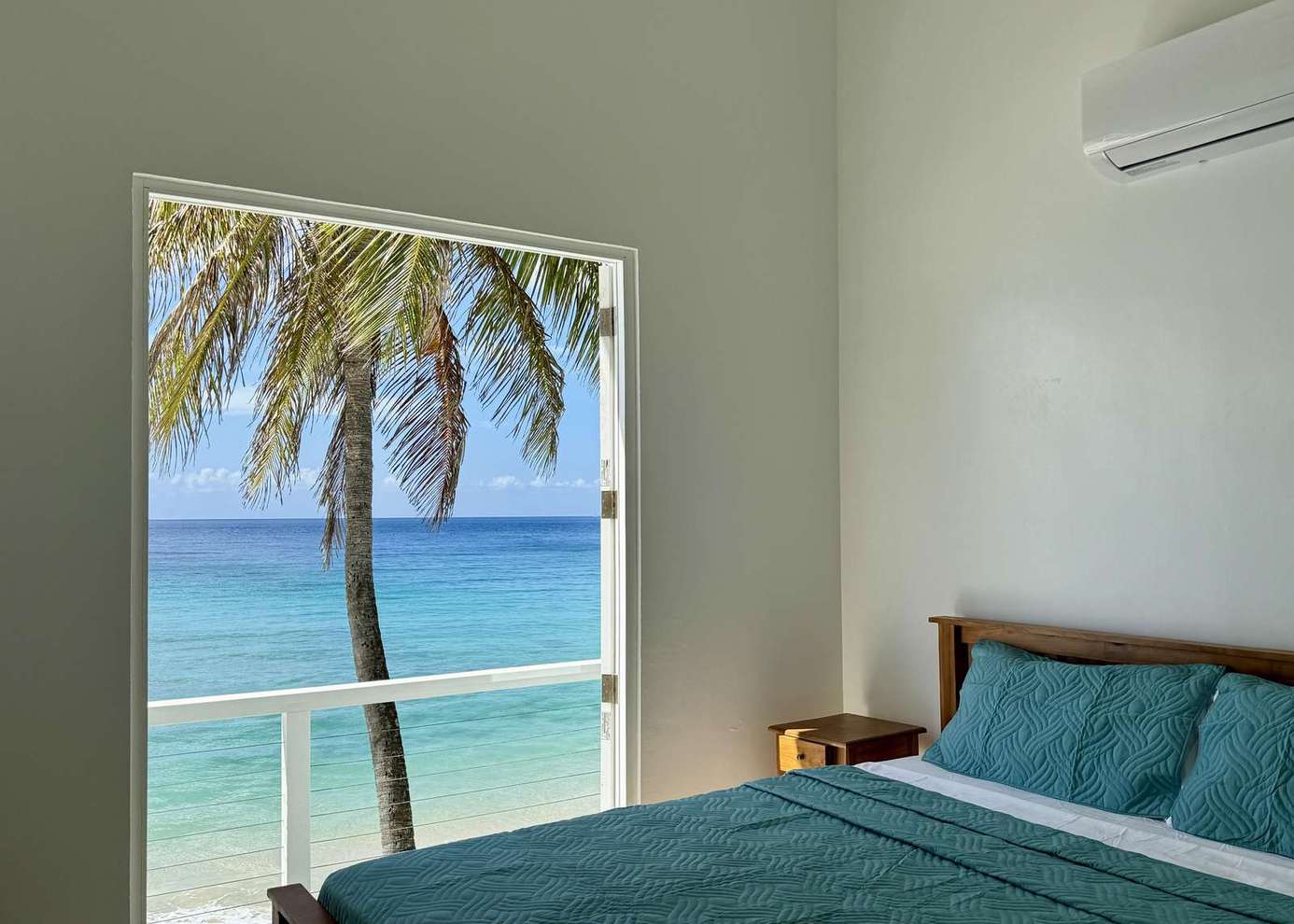 Oceanfront bedroom with stunning palm tree views and sea breeze