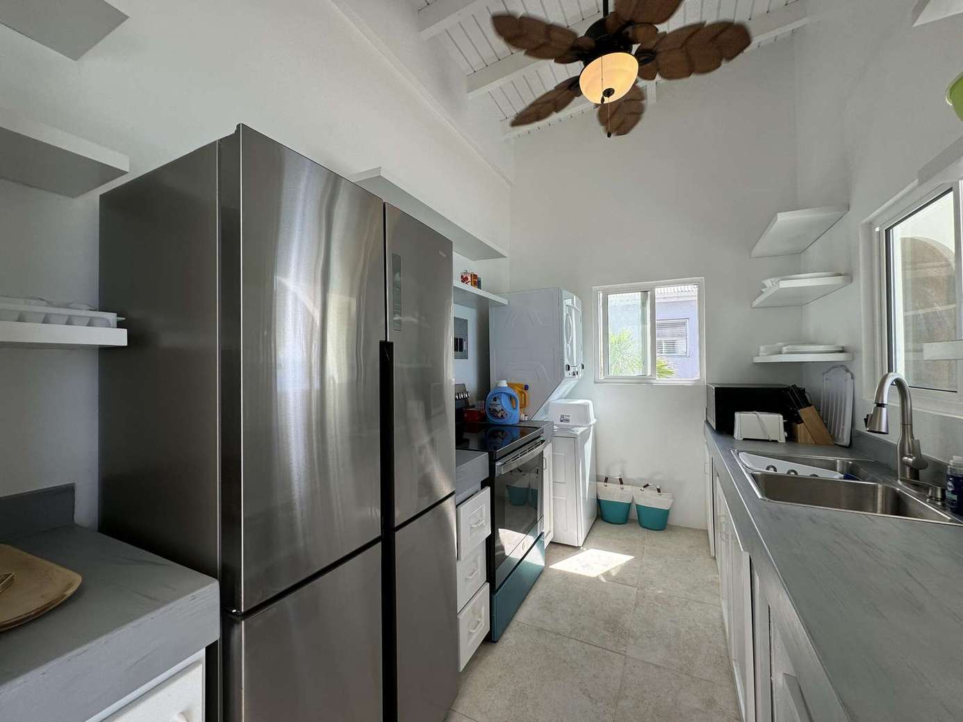 Bright, modern kitchen with stainless steel appliances and natural light