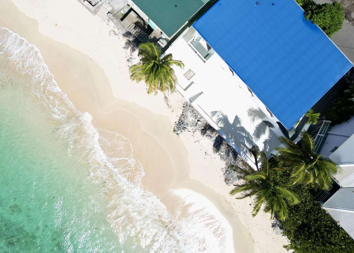 Secluded beachfront retreat with turquoise waters and swaying palms