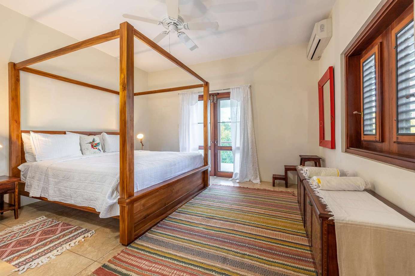 Spacious bedroom with elegant canopy bed and cozy seating area