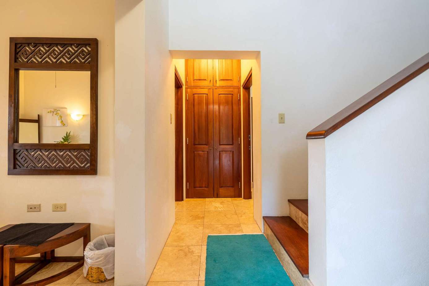 Welcoming entryway with warm lighting and wooden accents