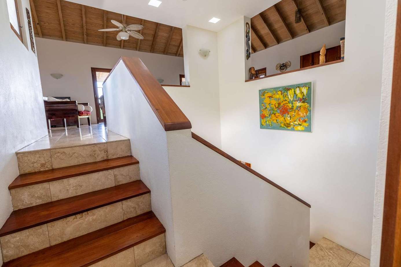 Bright stairway leading to open-concept living and dining area