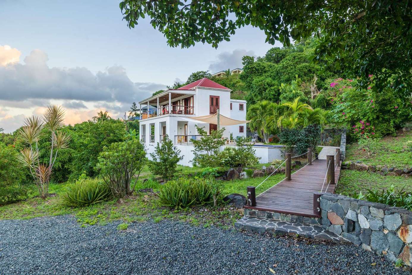 Charming hillside villa with spacious outdoor terrace and lush greenery