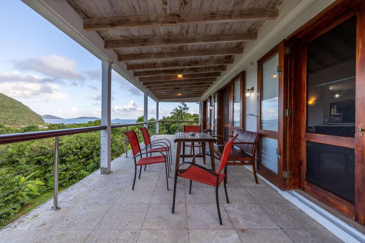 Spacious covered patio with scenic mountain views and cozy seating