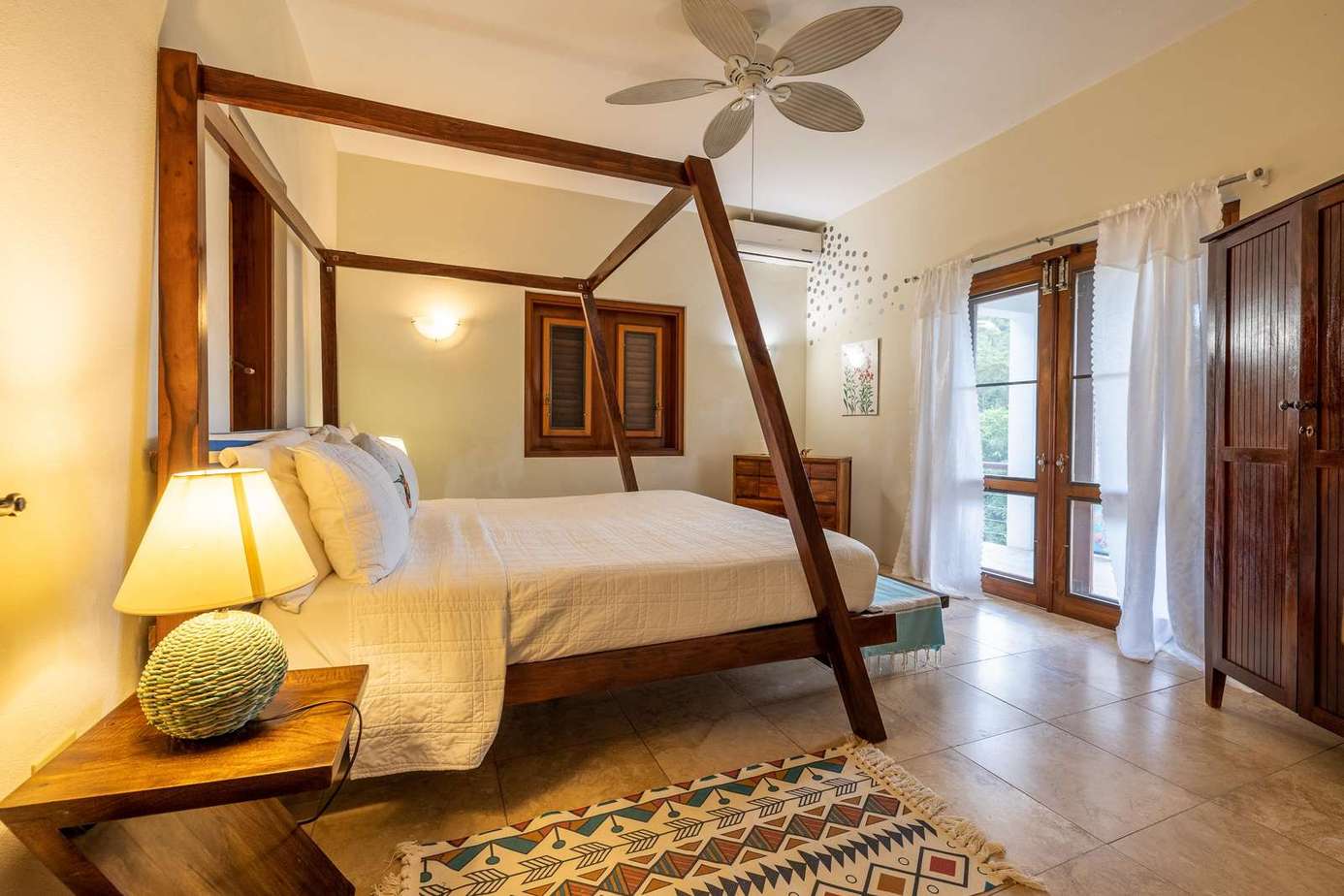 Spacious bedroom with cozy canopy bed and natural light