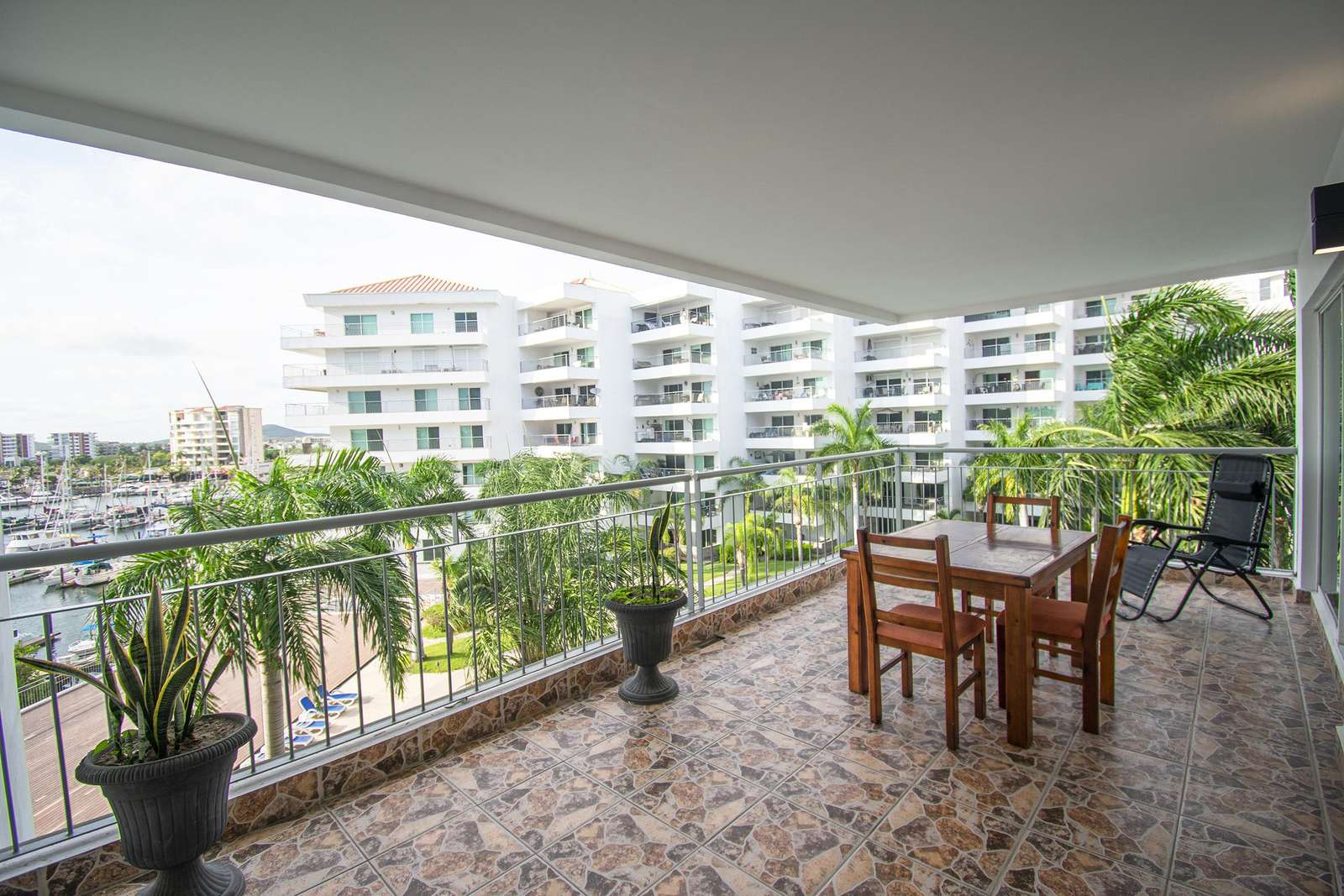 Spacious balcony with waterfront views and cozy dining area - property
