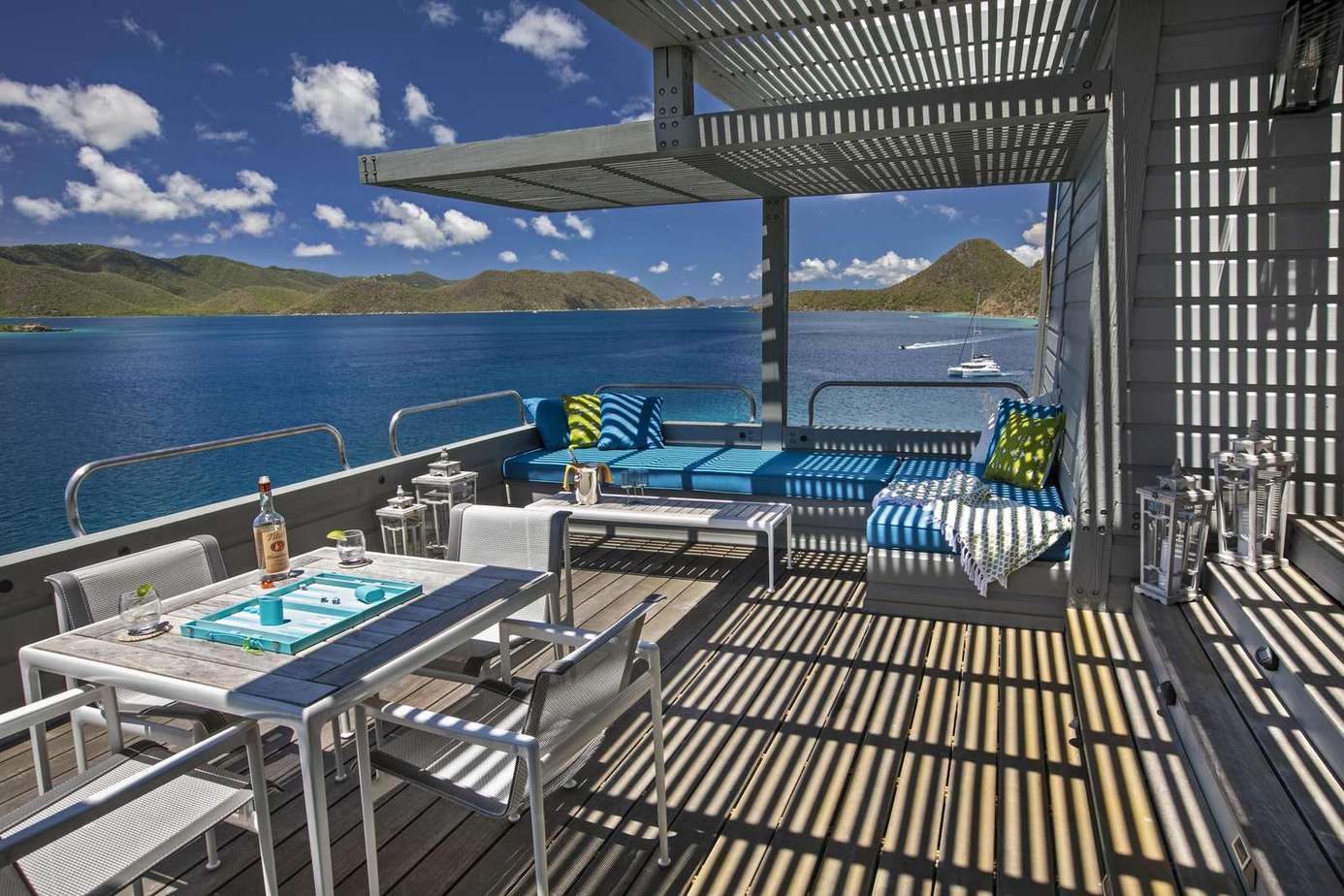 Sunlit patio with panoramic water and mountain views