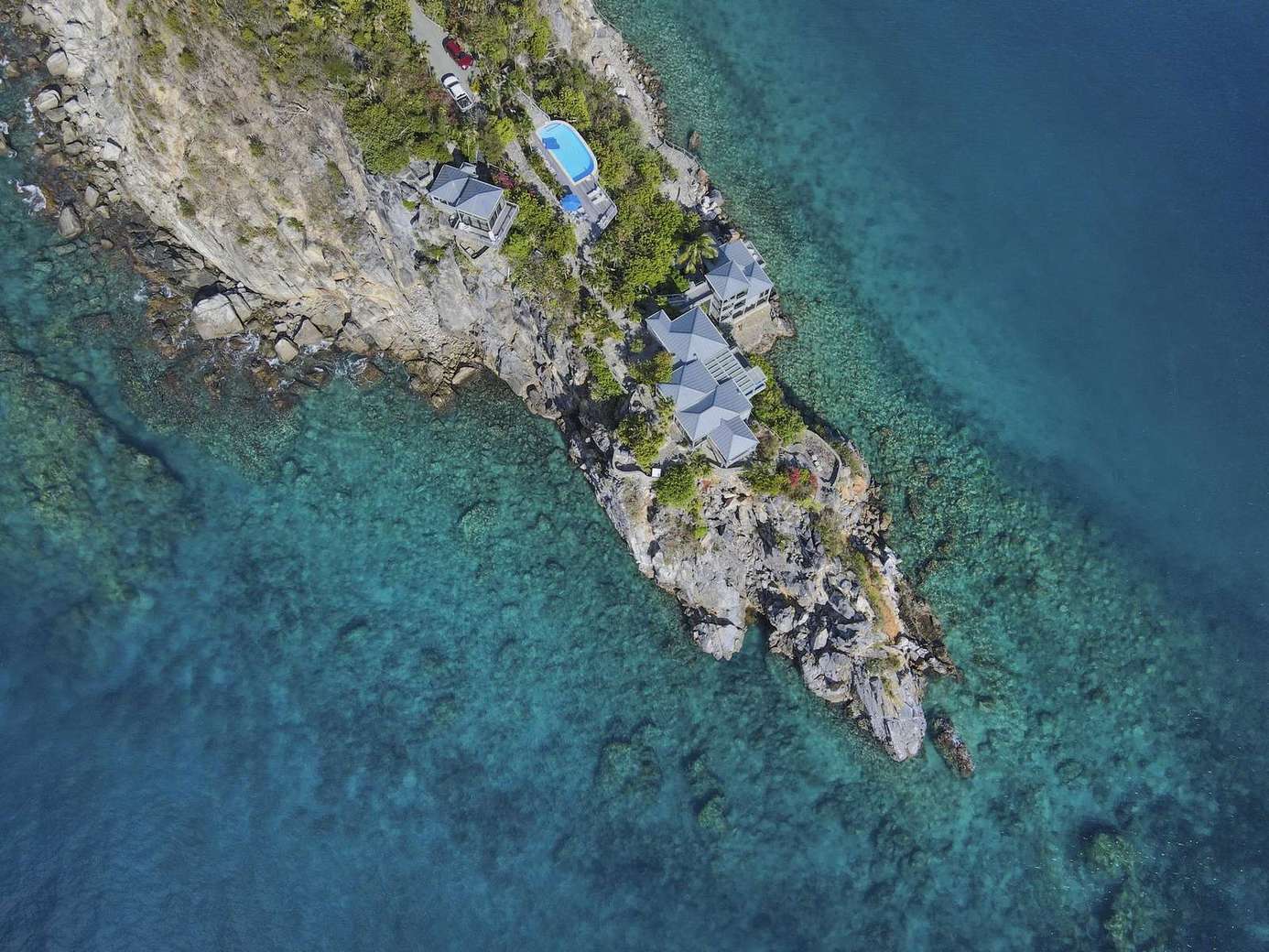 Secluded rocky shoreline with crystal-clear turquoise waters