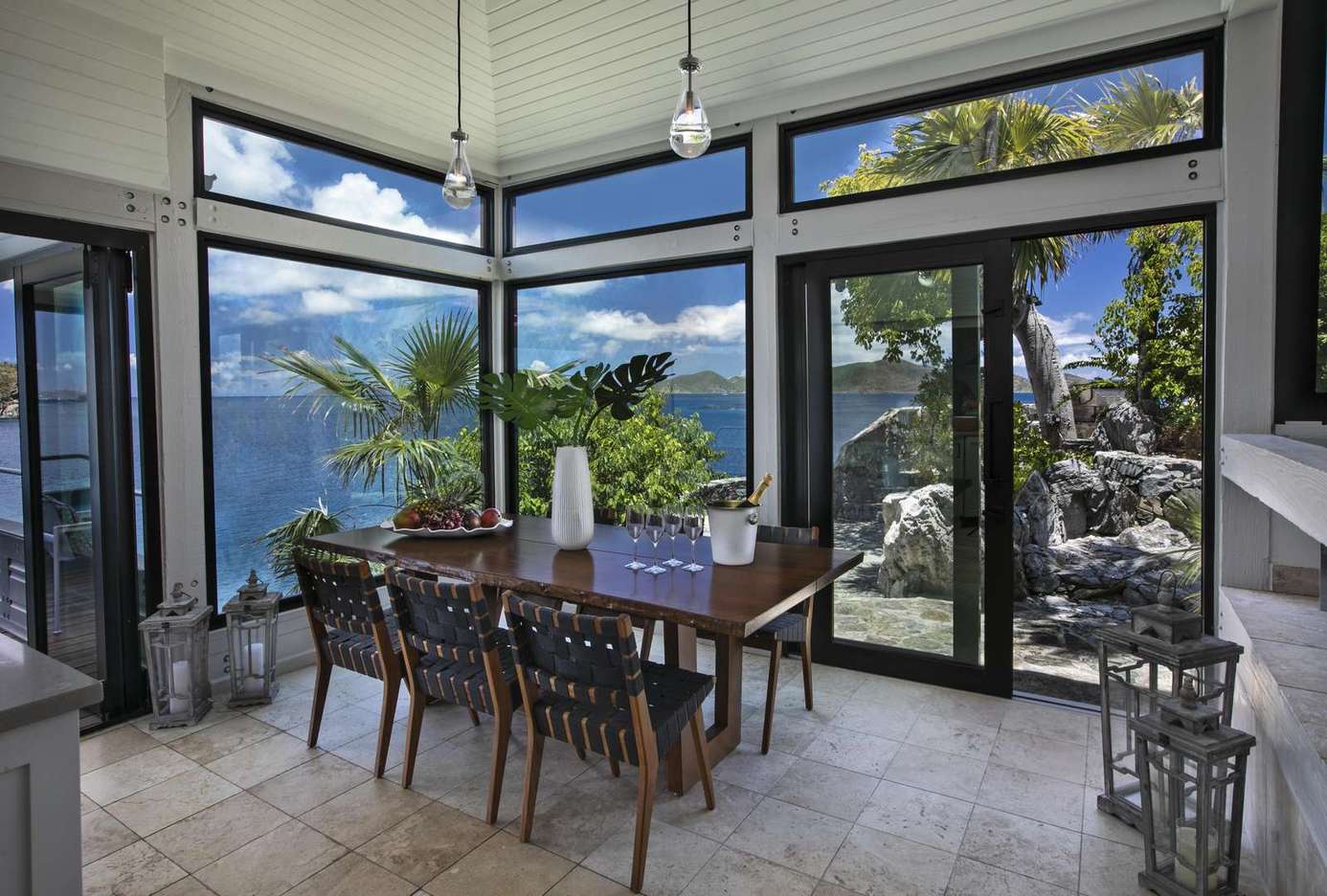 Sunlit dining area with stunning lake and mountain views