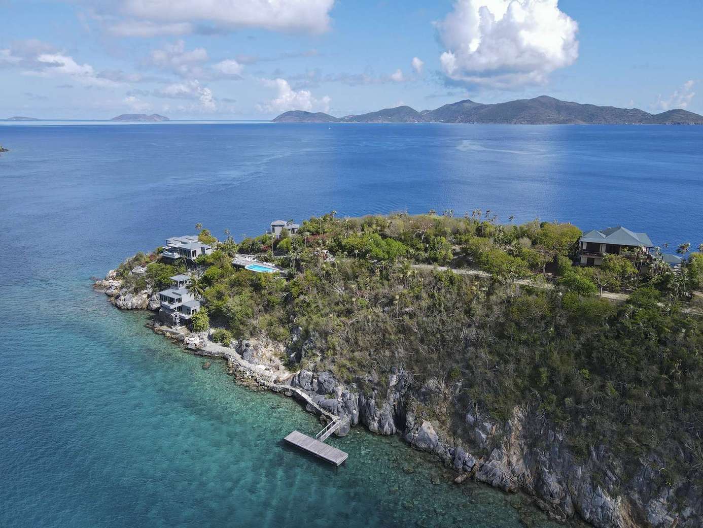 Secluded island retreat with crystal-clear waters and private dock