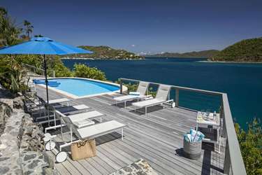 Sun-drenched pool deck with stunning waterfront views