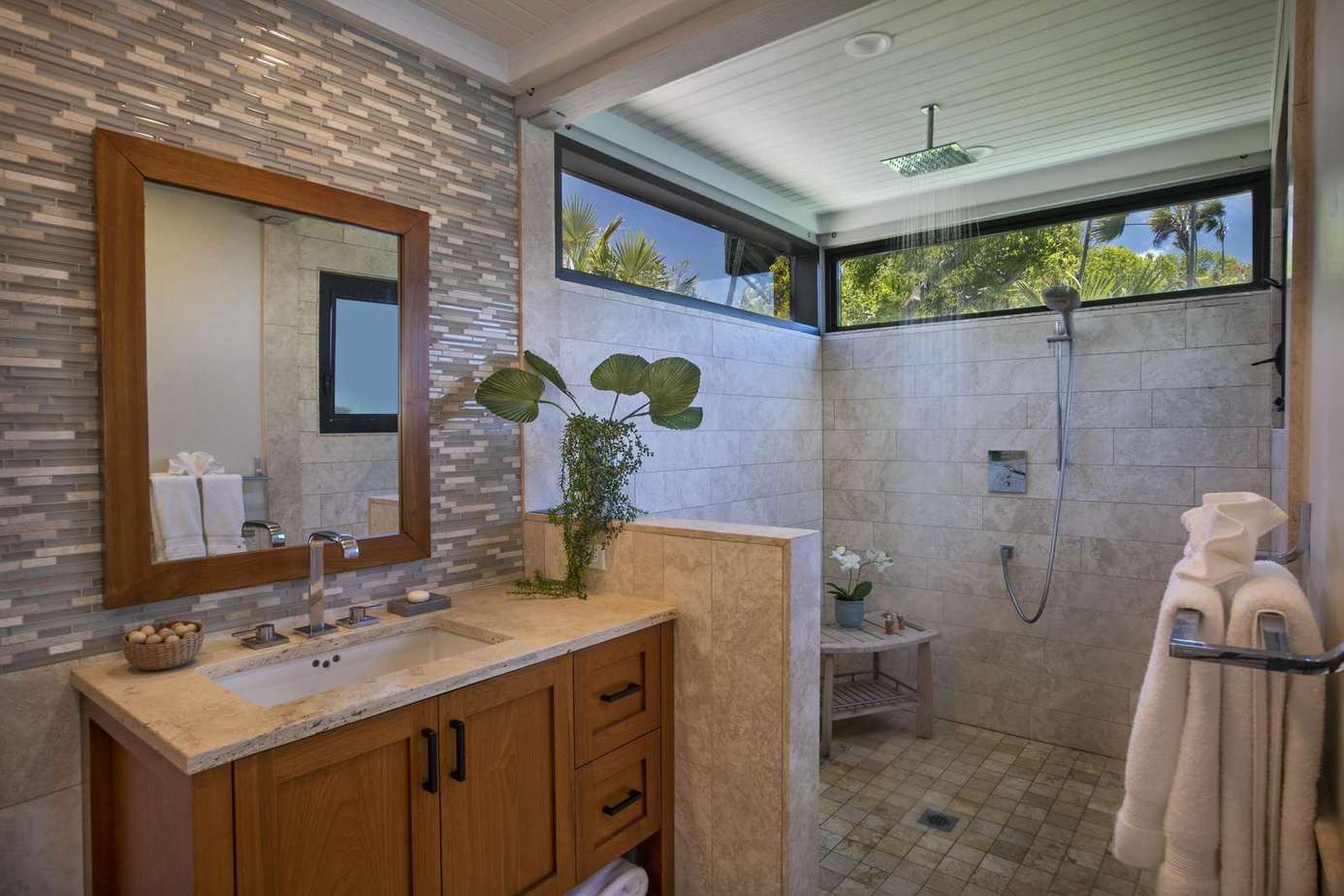 Modern bathroom retreat with natural stone accents and spacious walk-in shower
