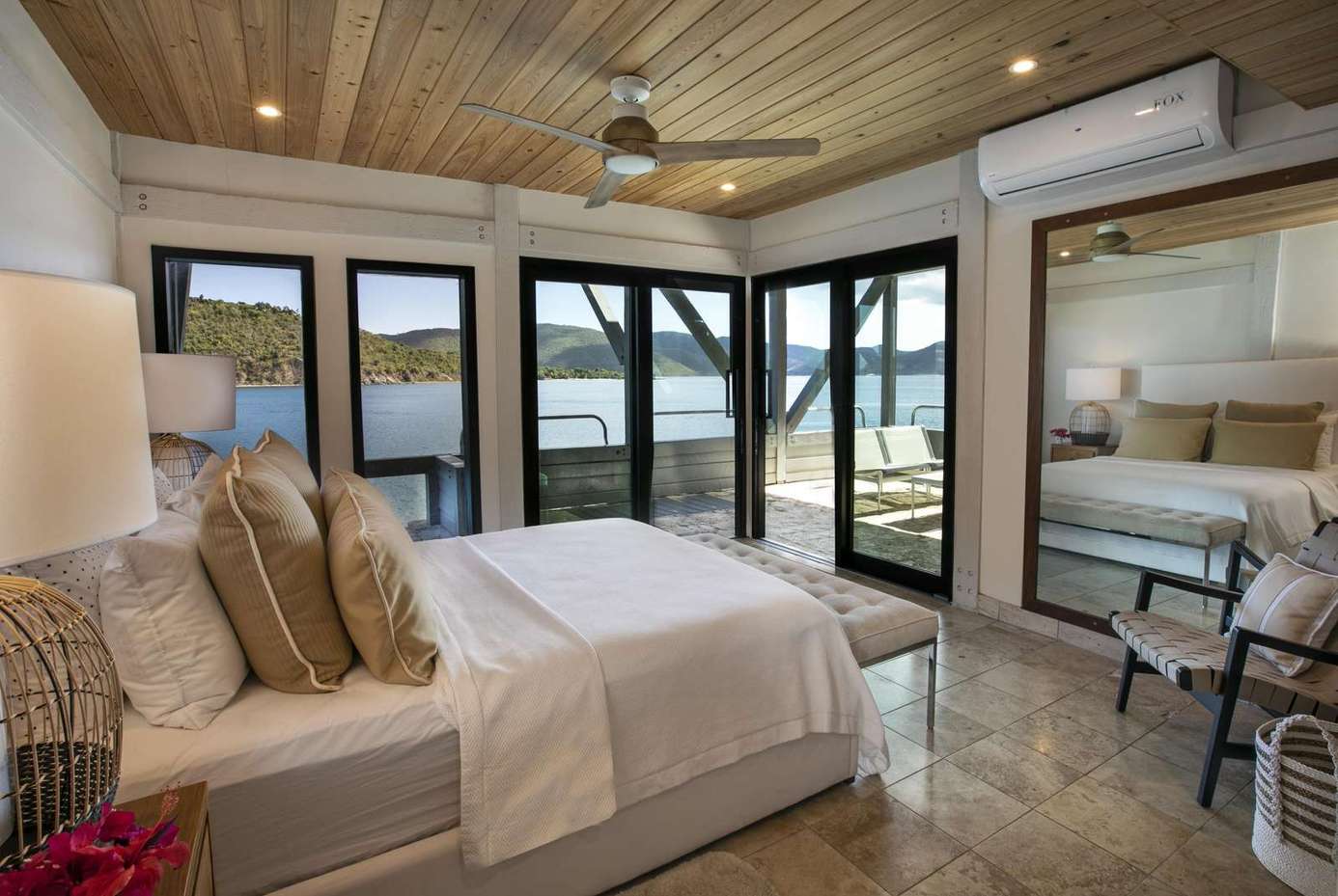 Serene lakeside bedroom with panoramic water views and natural light