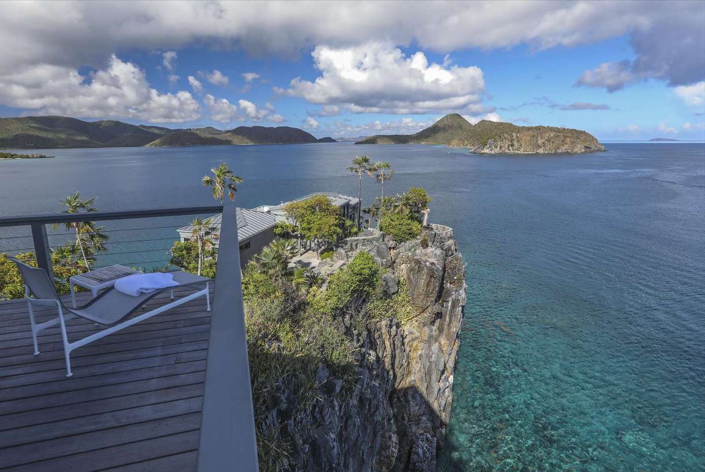 Cliffside deck with panoramic ocean views and lounge seating