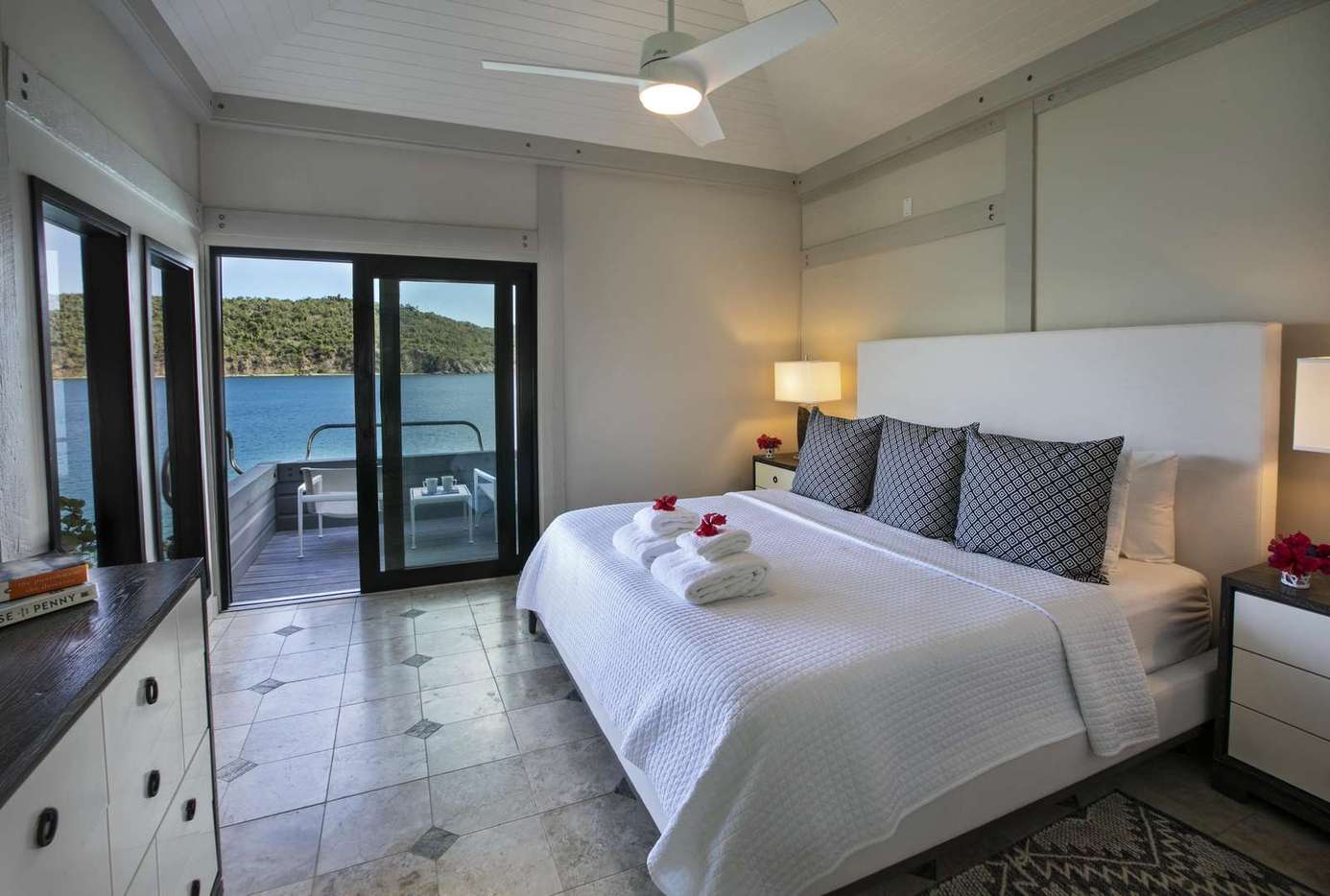 Serene bedroom with waterfront views and private balcony