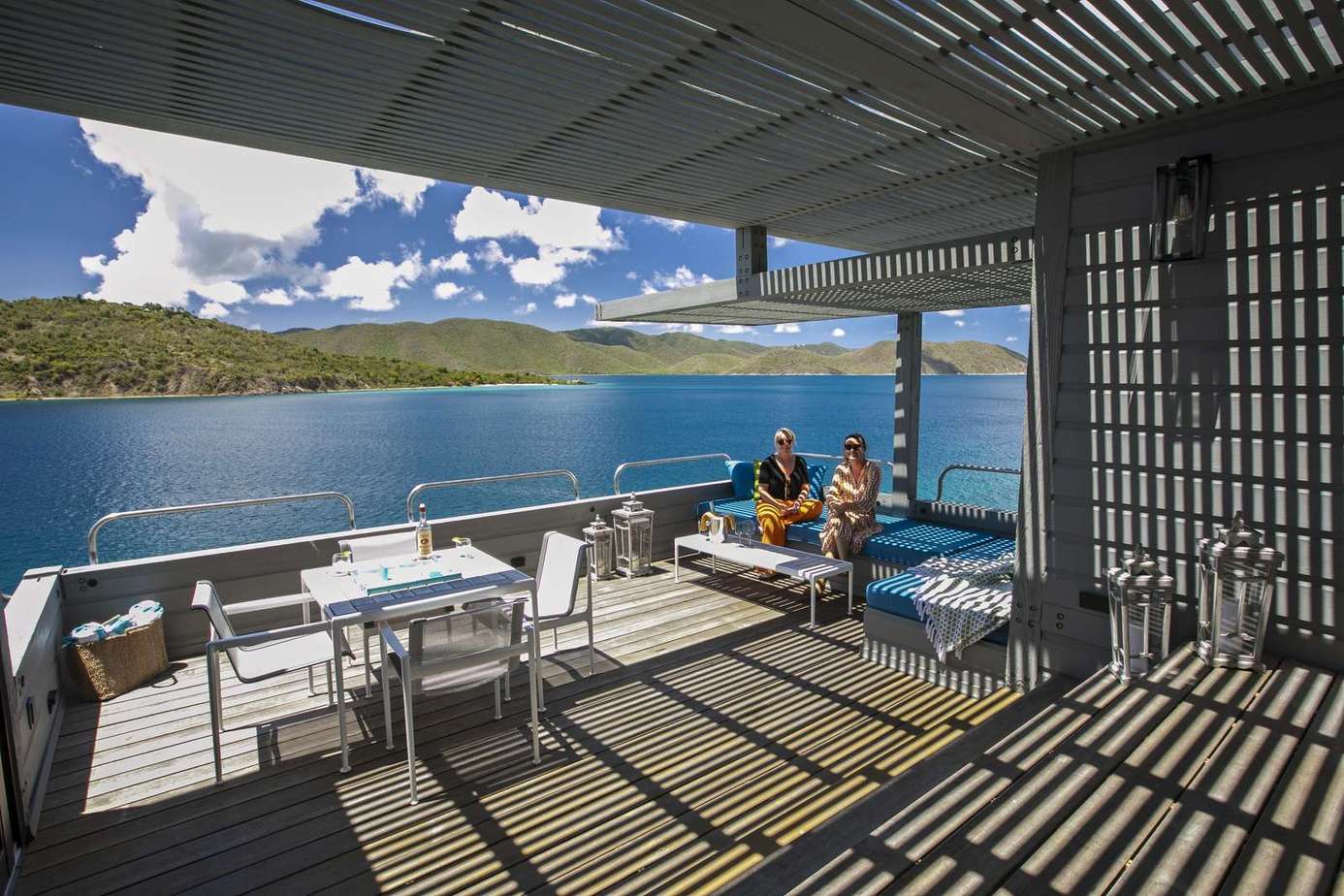 Spacious lakeside patio with stunning water views and dining area
