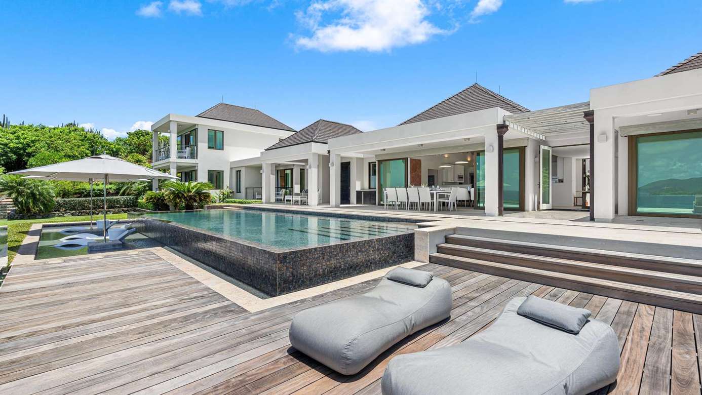 Sun-drenched poolside deck with modern lounge seating