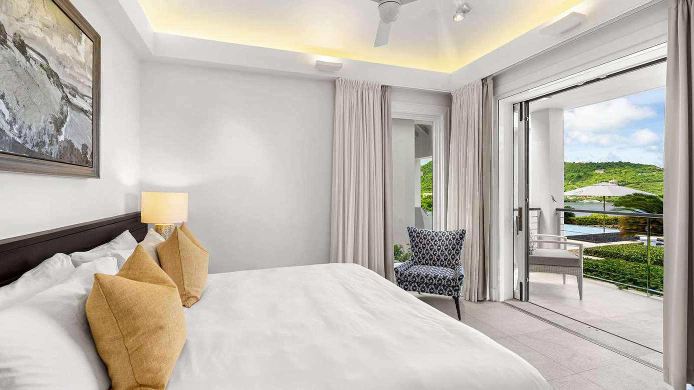 Bright bedroom with private balcony and scenic views