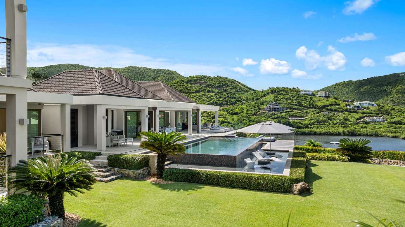 Lush garden and infinity pool with stunning mountain views