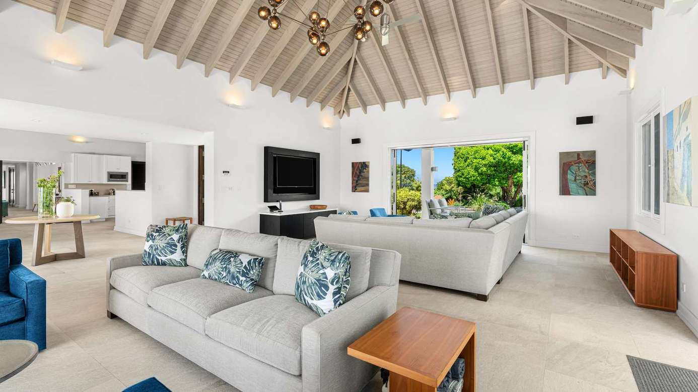 Spacious living room with vaulted ceilings and garden views