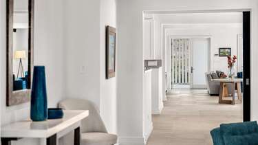 Bright, airy hallway leading to spacious living areas