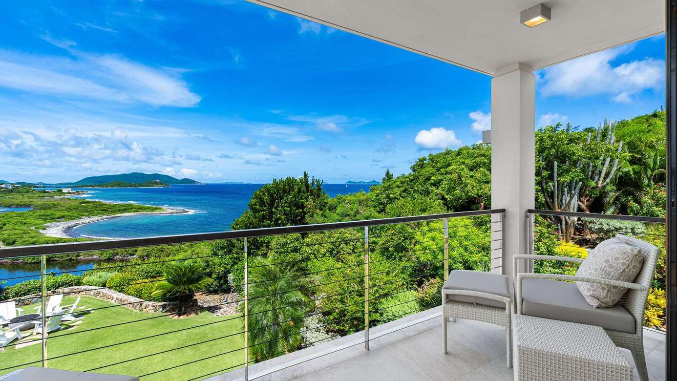 Serene balcony retreat with stunning ocean views and lush greenery