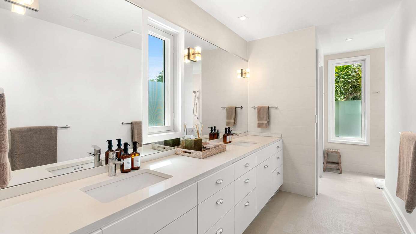 Bright, airy bathroom with double vanity and natural light