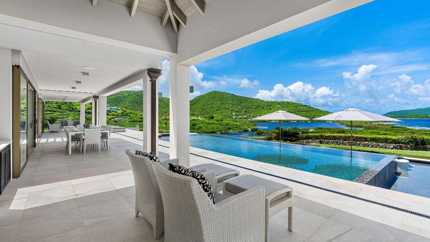 Spacious covered patio with stunning pool and mountain views