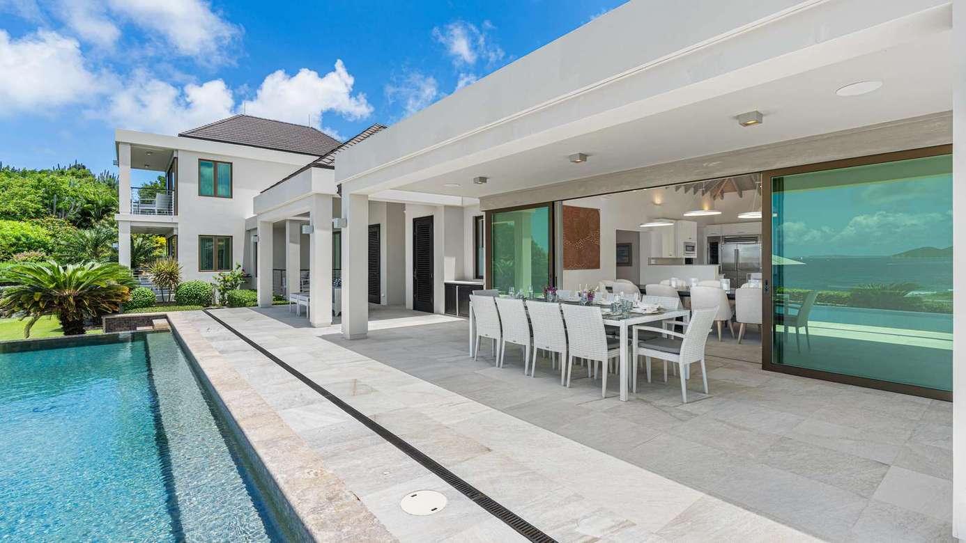 Sleek outdoor dining and poolside lounge for sunny gatherings