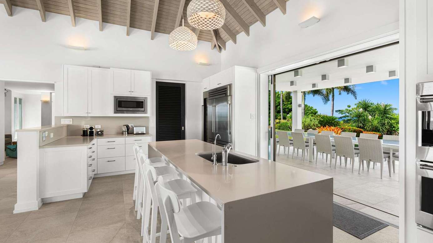 Bright, open kitchen flowing seamlessly to outdoor dining area