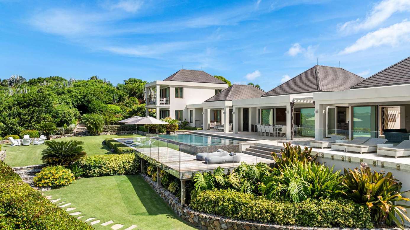 Spacious outdoor oasis with pool and lush garden views