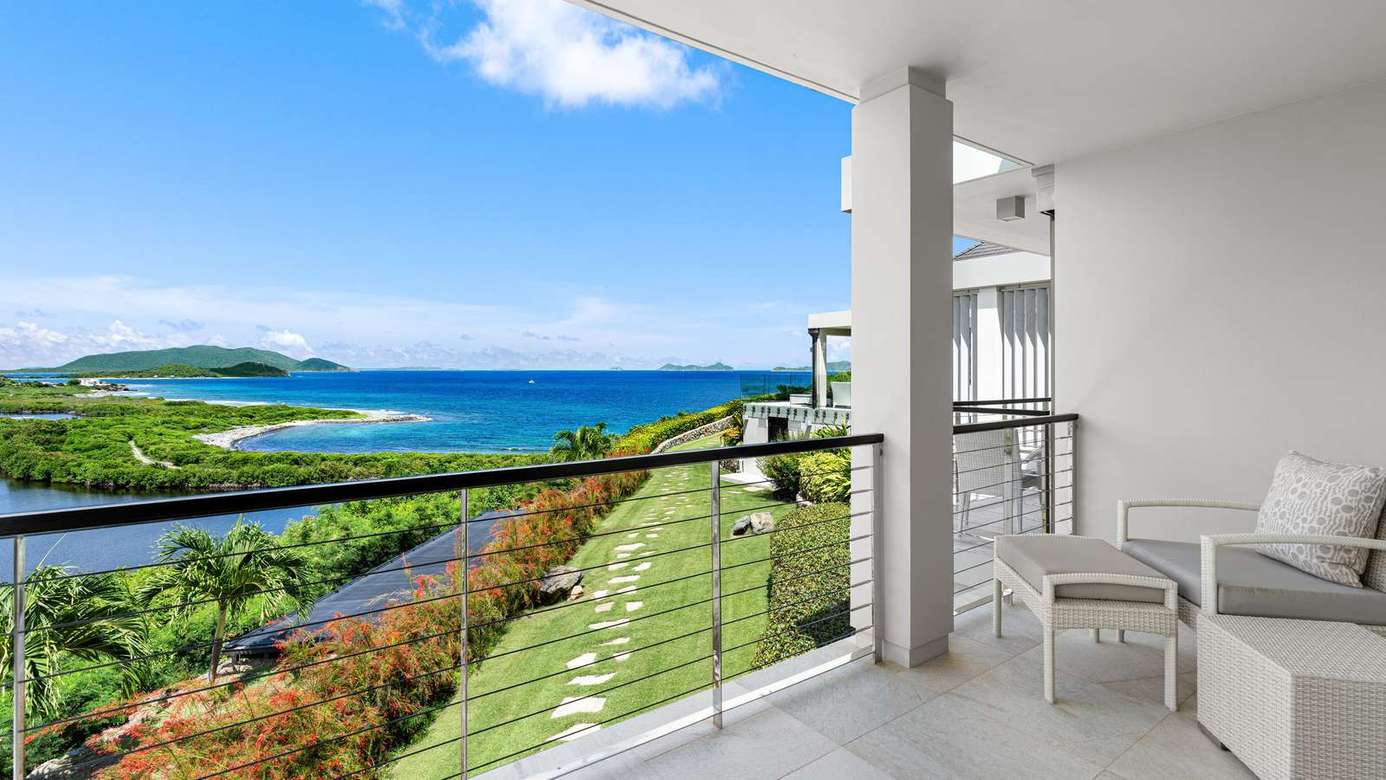 Ocean-view balcony with cozy seating and fresh sea breeze